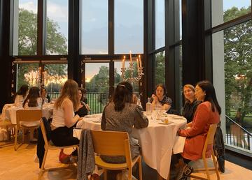 A table at the banquet dinner at St Hilda's college - a group of people sat around a table