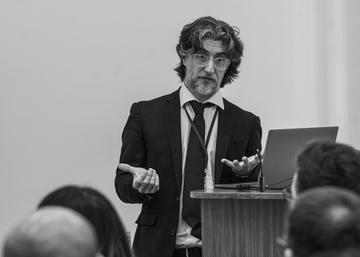 Alex Silverman stands next to a lectern