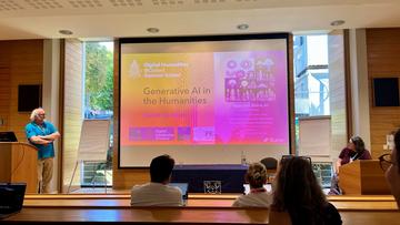 A lecture theatre - the slide shown says "Generative AI in the Humanities - David De Roure"