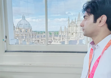 Muhammad Zahid Iqbal pictured in profile with Oxford college buildings in the background
