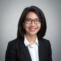 Felippa Amanta smiling wearing glasses and a blazer