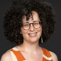 Victoria Van Hyning smiling and wearing glasses
